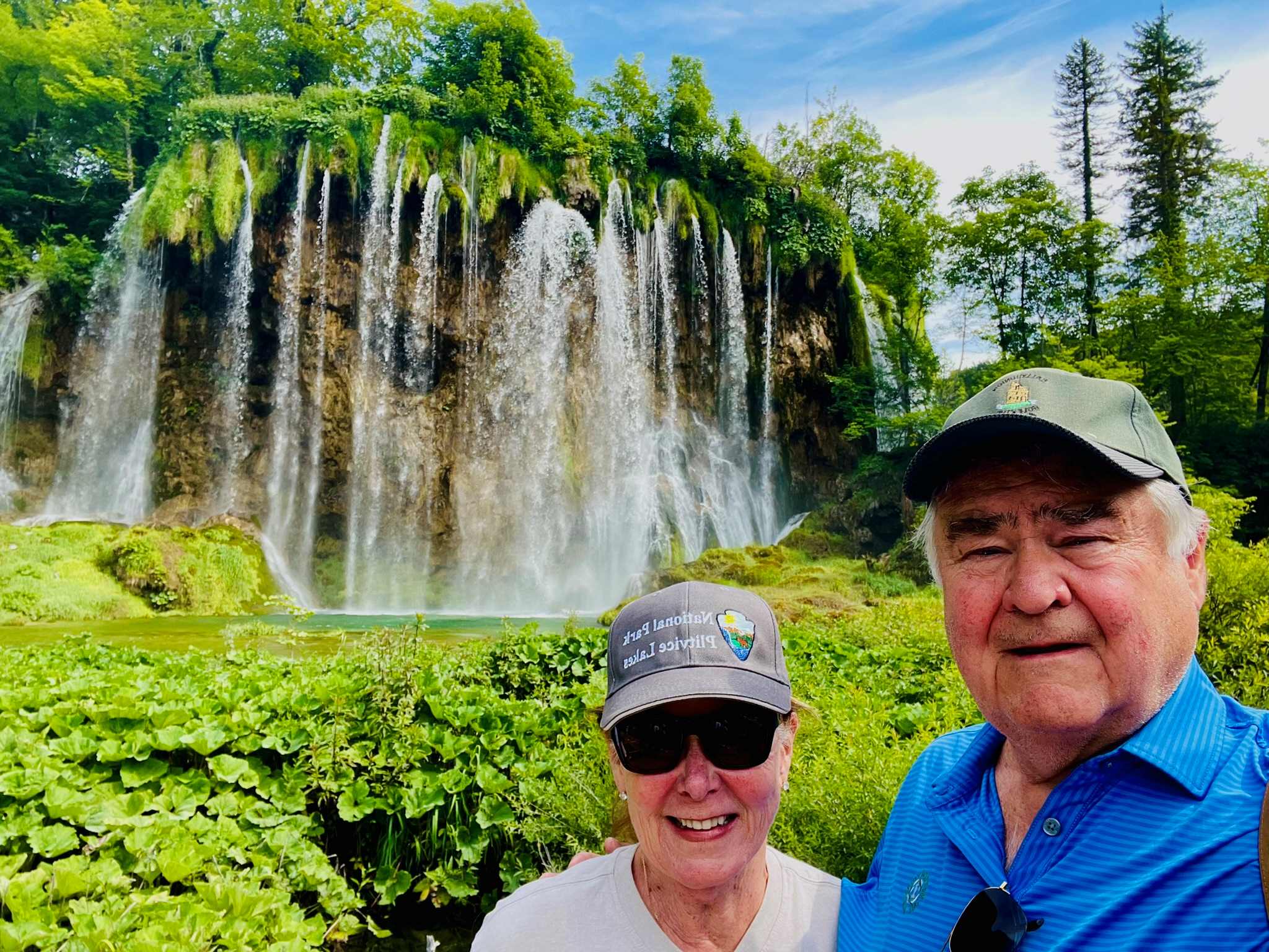 Robin and Paul in Croatia, Plitvice Lakes National Park enjoying the waterfalls behind them